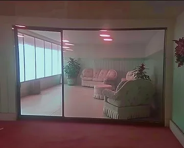 Glass-walled room filled with plants.