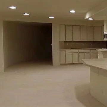 Empty beige kitchen and living room.