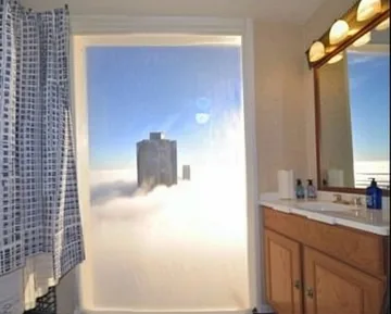 Bathroom opening onto towers above clouds.