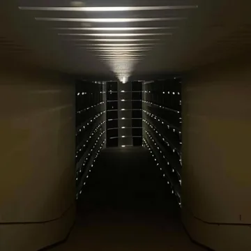 Long dark aisle with repeating lights.