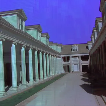 Pale colonnade under a deep blue sky.
