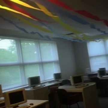 Streamers above old computers in a room.