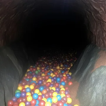 Colored balls at the bottom of a dark tunnel.