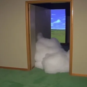 Cloud spilling through a doorway onto green carpet.