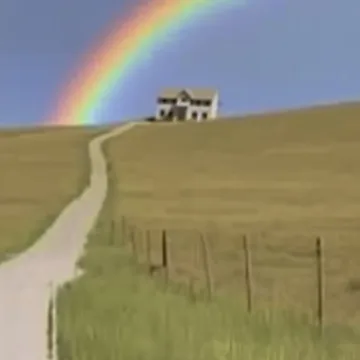 Rainbow over a house at the end of a path.