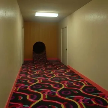 Patterned carpet leading to a circular play tunnel.