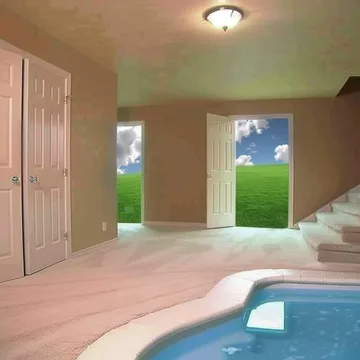 Pool inside a pastel room opening onto green hills.