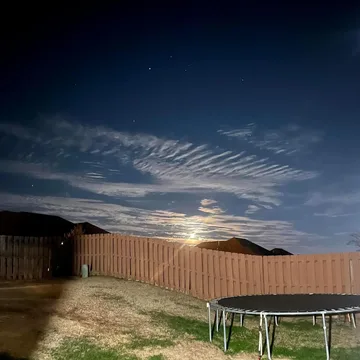 Trampoline beneath a dramatic evening sky.
