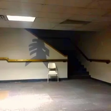 Single chair beside an empty staircase.