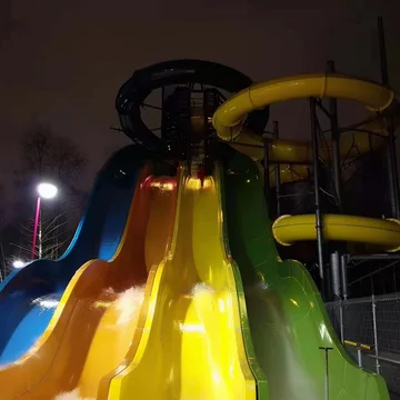 Bright yellow water slides against a black sky.