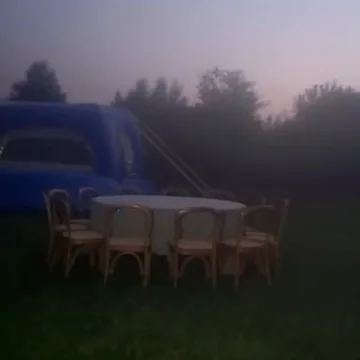 Old computers outdoors beneath a pale dusk sky.