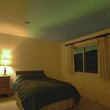 Bedroom lit by a green lamp.