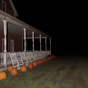 Pumpkins along a white porch at night.
