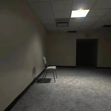 Single chair in an empty gray room.
