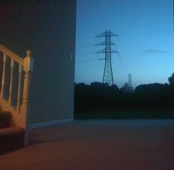 Open doorway facing power lines in the evening.