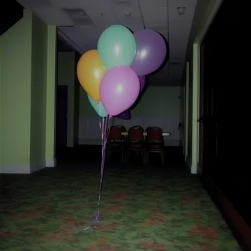 Balloons beside a dark hallway.