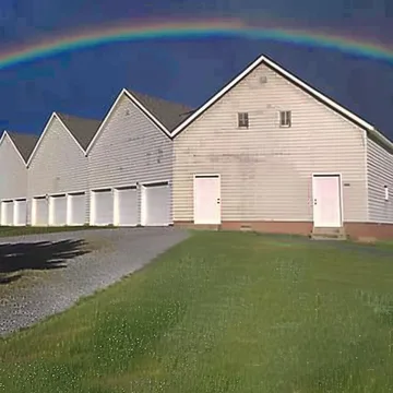 Rainbow over a row of white houses.