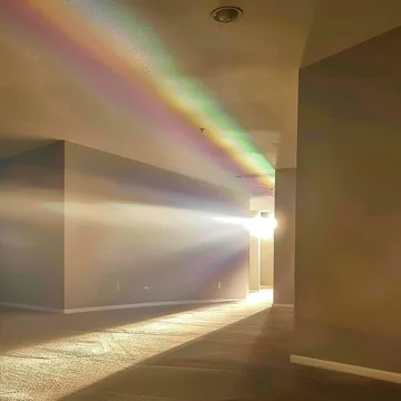 Rainbow light streaking across a room.
