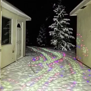 Snow outside a house with rainbow reflections.