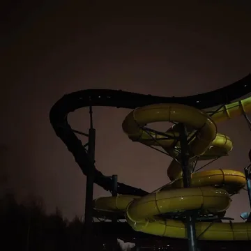 Twisting water slide against a dark sky.