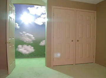 Open door onto grass and luminous clouds.