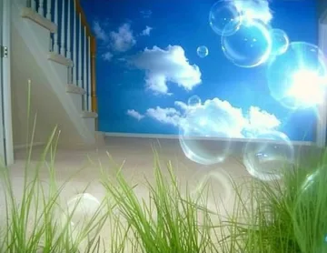 Bubbles and grass beside a bright sky opening.
