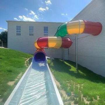 Water slide between houses under blue sky.