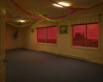 Streamers and red windows in an empty room.