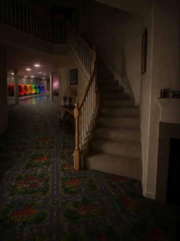 Staircase in a dark decorated hallway.