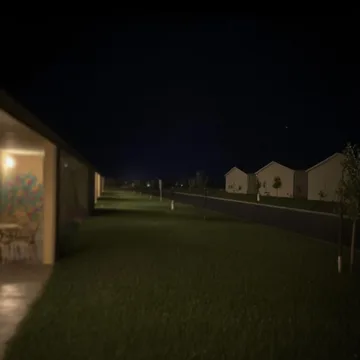 Dark yard between quiet houses at night.
