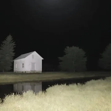 White house reflected in dark water.