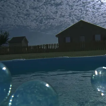 Dark pool outside a house beneath a textured sky.