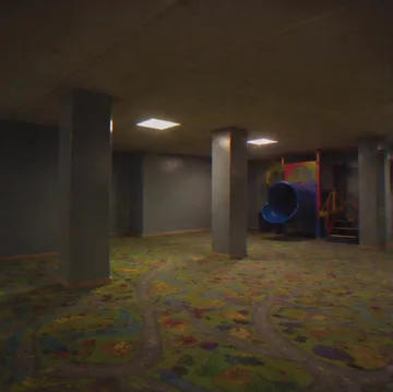 Pillars in a dim playroom with colorful flooring.