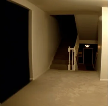 Dark opening beside a pale kitchen corridor.
