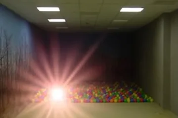 Light flaring beside a ball pit in a basement.