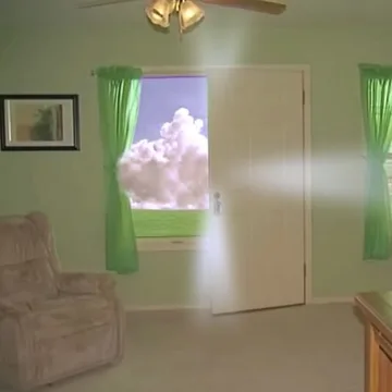 Bright clouds beyond green curtains in an empty room.