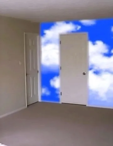 White door standing before a blue cloud-filled wall.