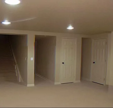 Empty beige room with open doorways.